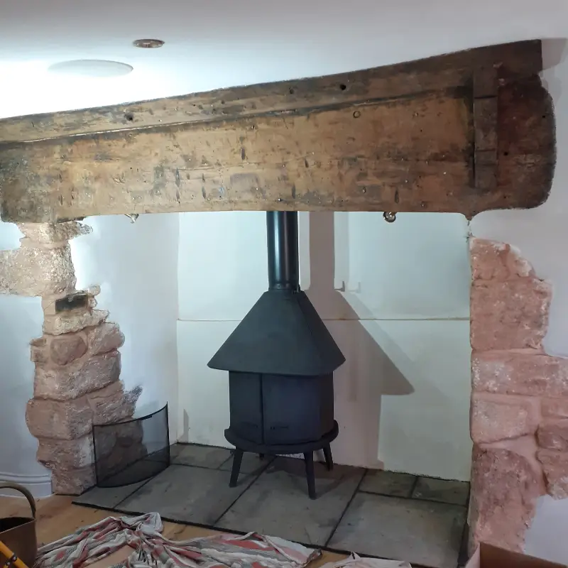 Fireplace renovation using lime render and installation of a slate hearth.