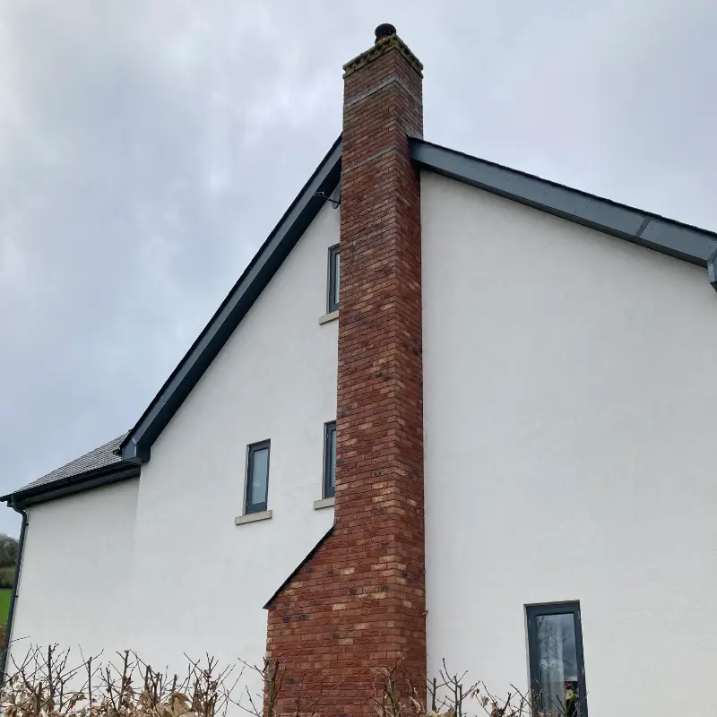 New build chimney using handmade bricks, with a decorative dog tooth capping.